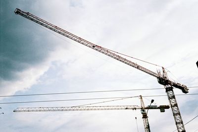 Low angle view of crane against sky