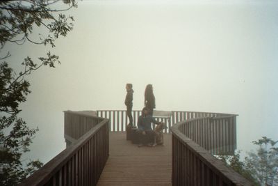 People looking at observation point against sky