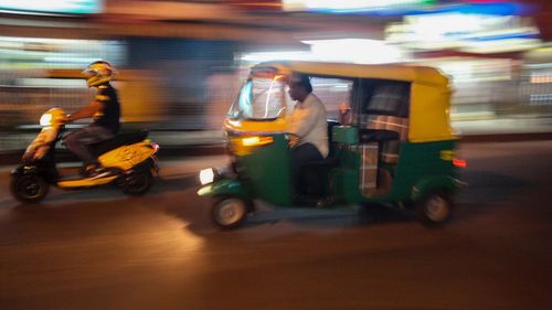 Blurred motion of people on road in city