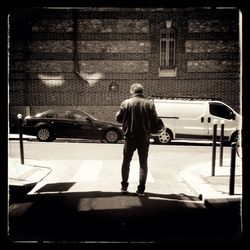 Full length of man standing on car