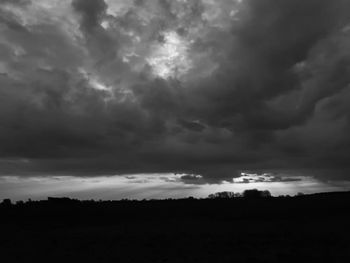 Storm clouds over silhouette landscape