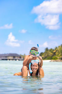 Mother and son snorkeling on the maldive islands