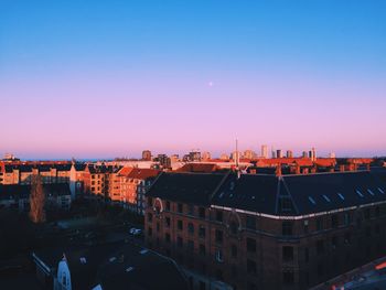 High angle view of buildings against clear sky during sunset