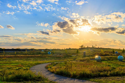 Scenic view of land against sky during sunset