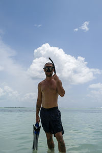 Man wearing snorkeling mask standing in the water