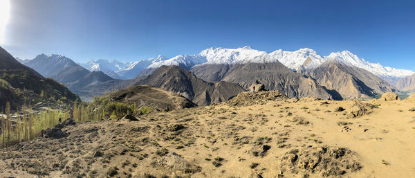 Panoramic view of snowcapped mountains against clear blue sky