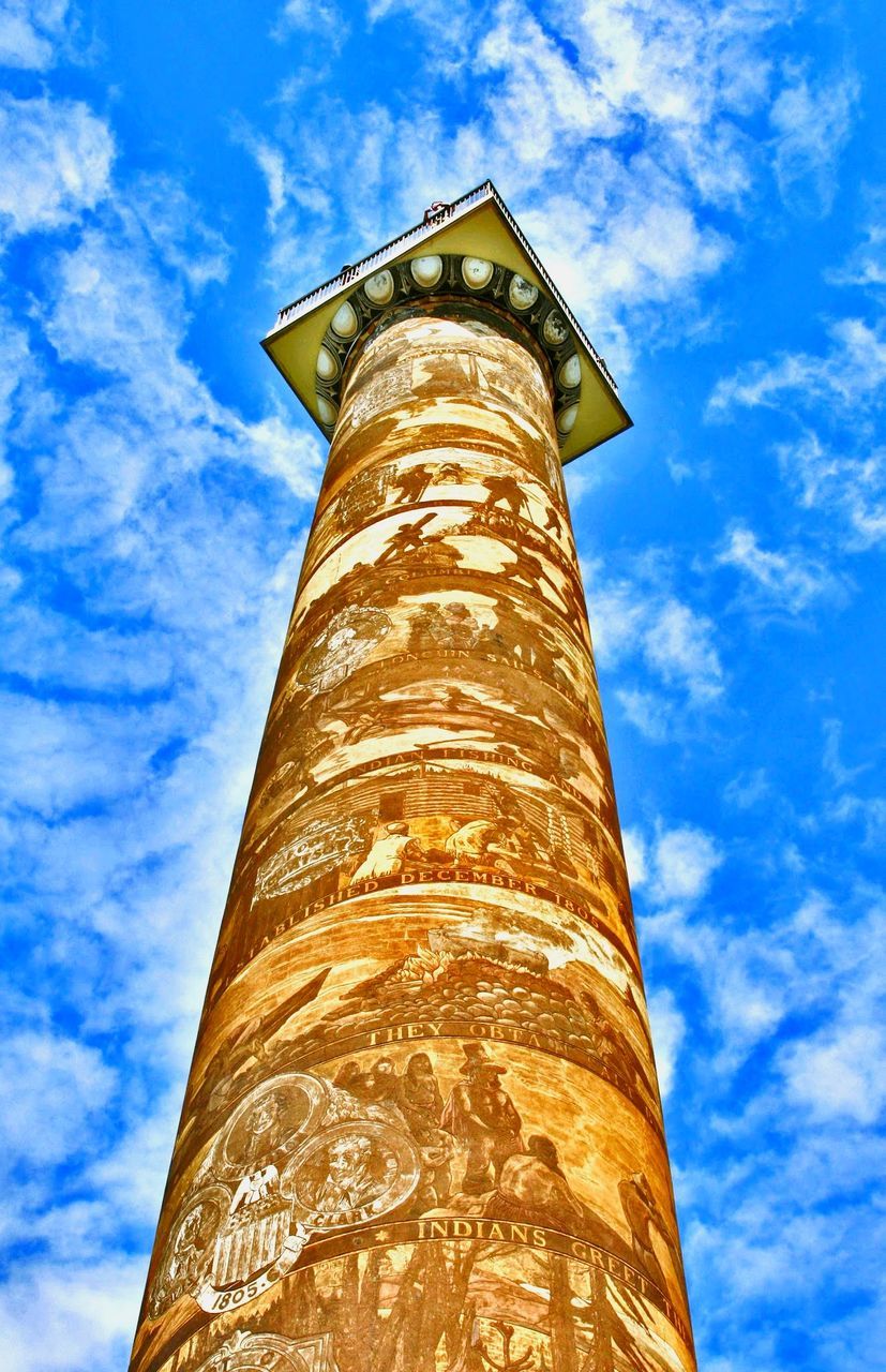 low angle view, sky, architecture, built structure, cloud - sky, tower, tall - high, no people, building exterior, nature, day, blue, outdoors, sunlight, building, lighthouse, guidance, travel destinations, architectural column, security