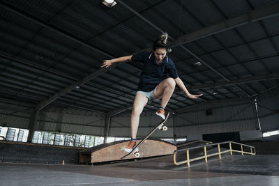 Full length of woman skateboarding on ramp