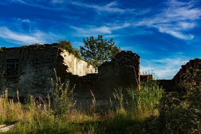 Built structure on field against sky