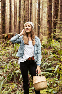 Beautiful woman forages in the rainforest near tofino