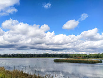 Scenic view of lake against sky, fish pond, blue sky.