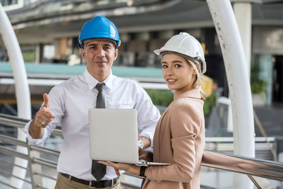 Portrait of engineers with laptop outdoors