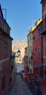 Alley amidst buildings in city against sky