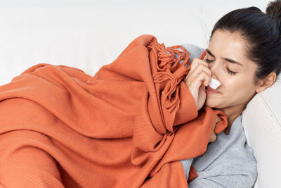 Portrait of woman relaxing on bed