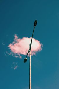 Low angle view of street light against blue sky