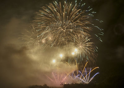 Low angle view of firework display at night