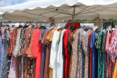 Stand of clothes at outdoor market in summer
