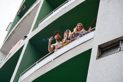 Low angle view of people walking on building