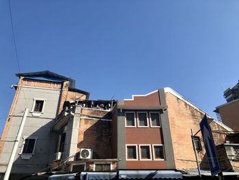 Low angle view of old building against clear blue sky