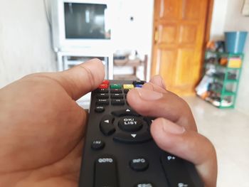 Someone is holding the remote control to turn off the tv