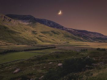 Scenic view of landscape against sky at night