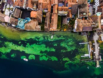 High angle view of sea by buildings in city