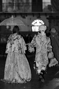 Rear view of people walking in temple