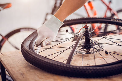 Close-up of hand holding bicycle wheel