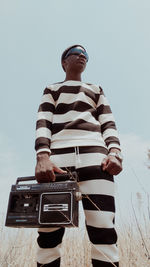 Rear view of man standing against clear sky