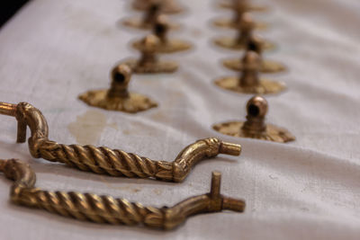 High angle view of metal furniture handles on table