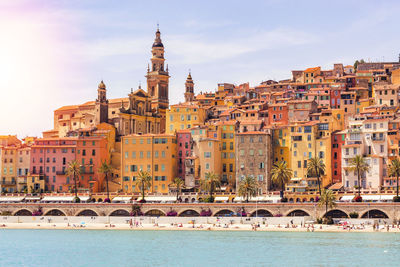 Arch bridge over river against buildings in city