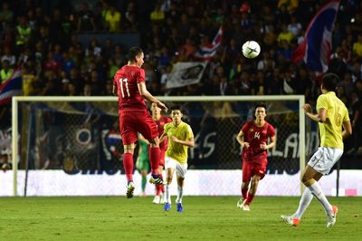 Group of people playing soccer on field