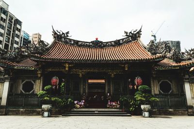 Facade of temple against building