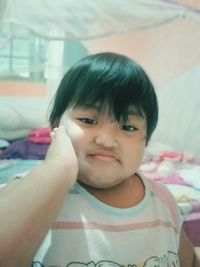 Close-up portrait of cute boy at home