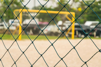 Rope net with blurred sand soccer field