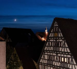 Buildings against sky at night