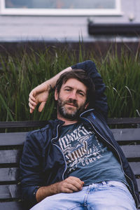 Portrait of young woman sitting on bench