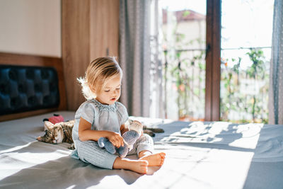 Cute boy sitting on sofa at home