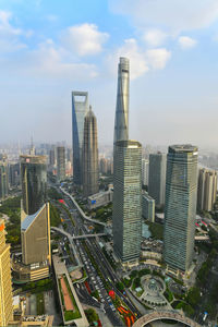 Aerial view of modern buildings in city against sky