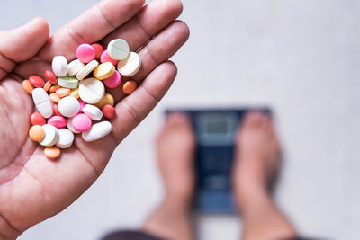 Cropped hand of person holding pills