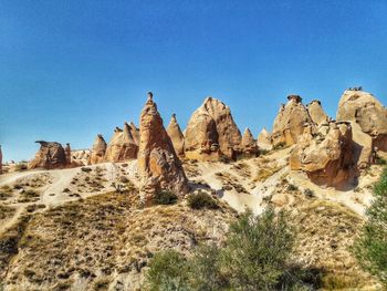 Rock formations in desert against clear blue sky