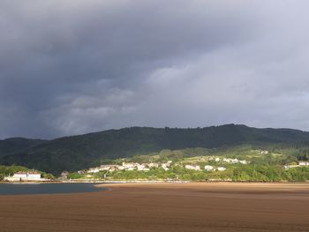 Mountain range against cloudy sky