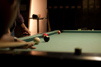 Cropped hand playing pool