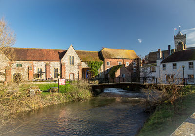 View of bridge over river against buildings