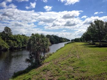 Scenic view of river against cloudy sky