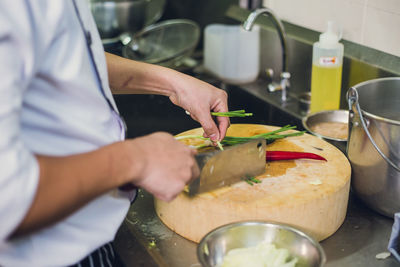 Close-up of man preparing food in kitchen