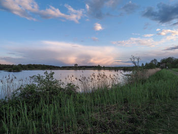 Scenic view of lake against sky during sunset