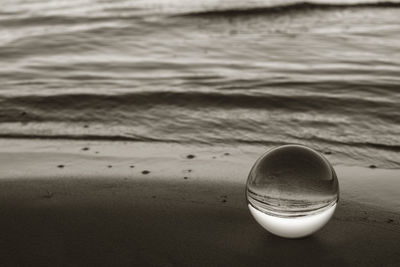 High angle view of crystal ball on beach