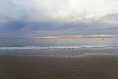 Scenic view of beach against sky during sunset