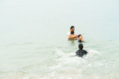 High angle view of people enjoying in sea